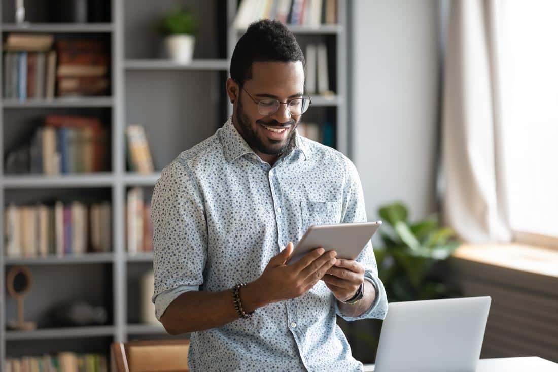 Man-smiling-using-ipad-inside Patient information