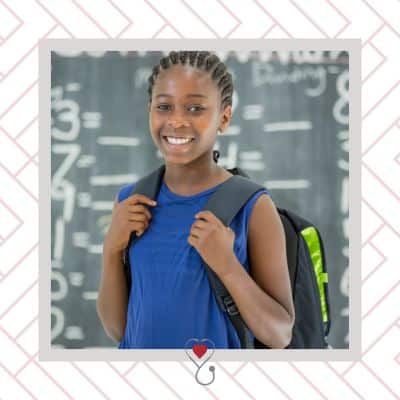 Everything about annual back-to-school physicals 6 Student wearing back pack in front of chalkboard