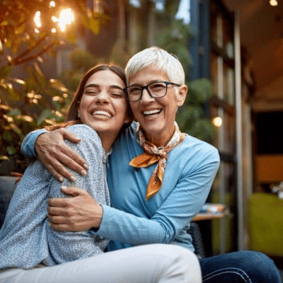 Mother and daughter hugging, representing women’s healthcare services