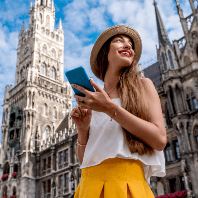 Woman traveling with old buildings behind her, representing travel health