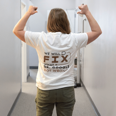 A woman in a white shirt with text on it that reads we will fix what dr. Google got wrong, representing best exercises for different ages